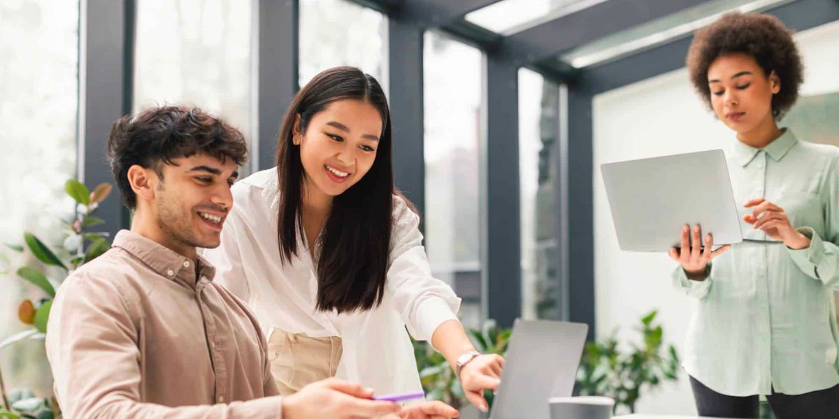 three young workers chatting in an office