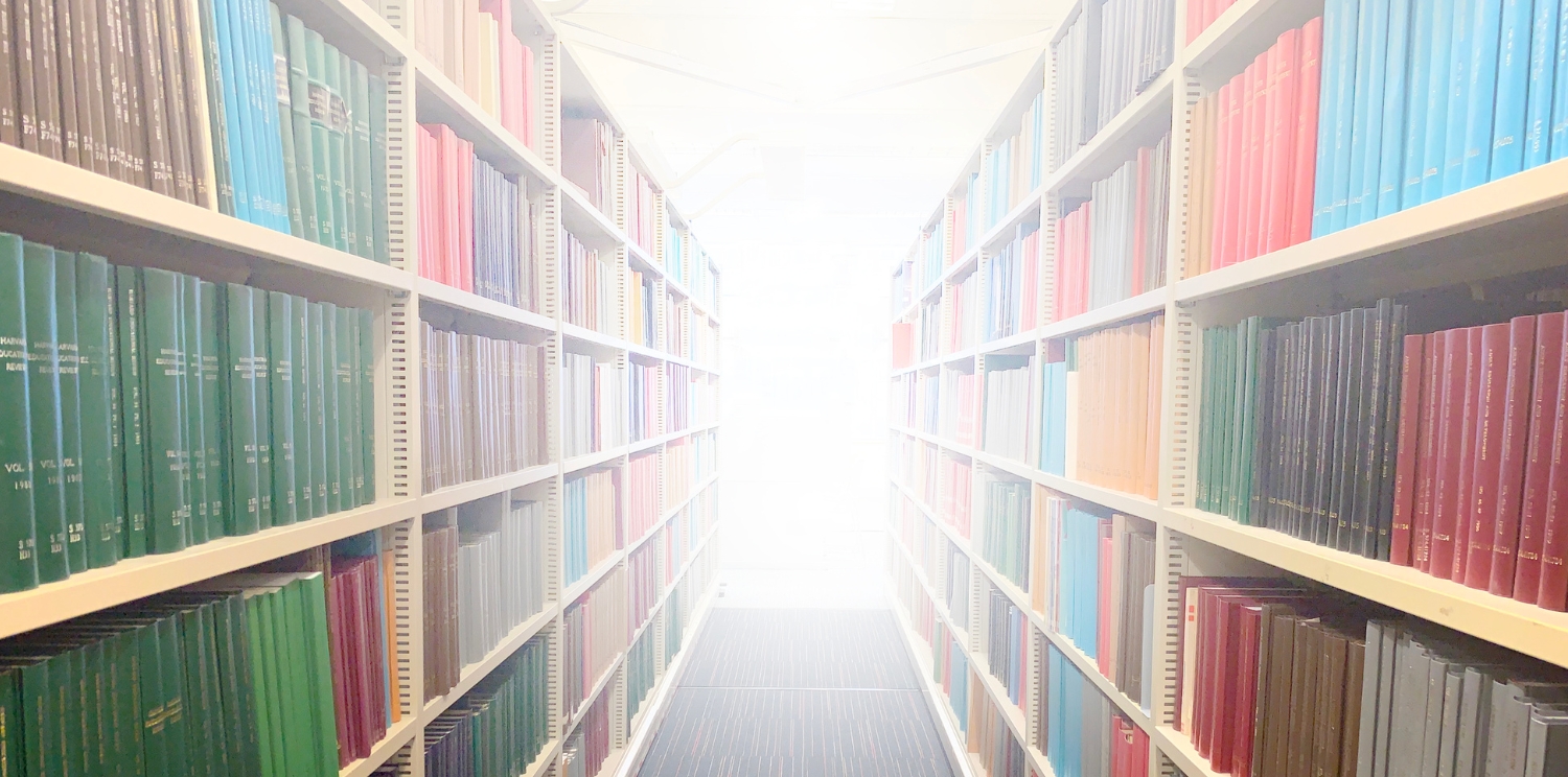 an aisle between book shelves in a library