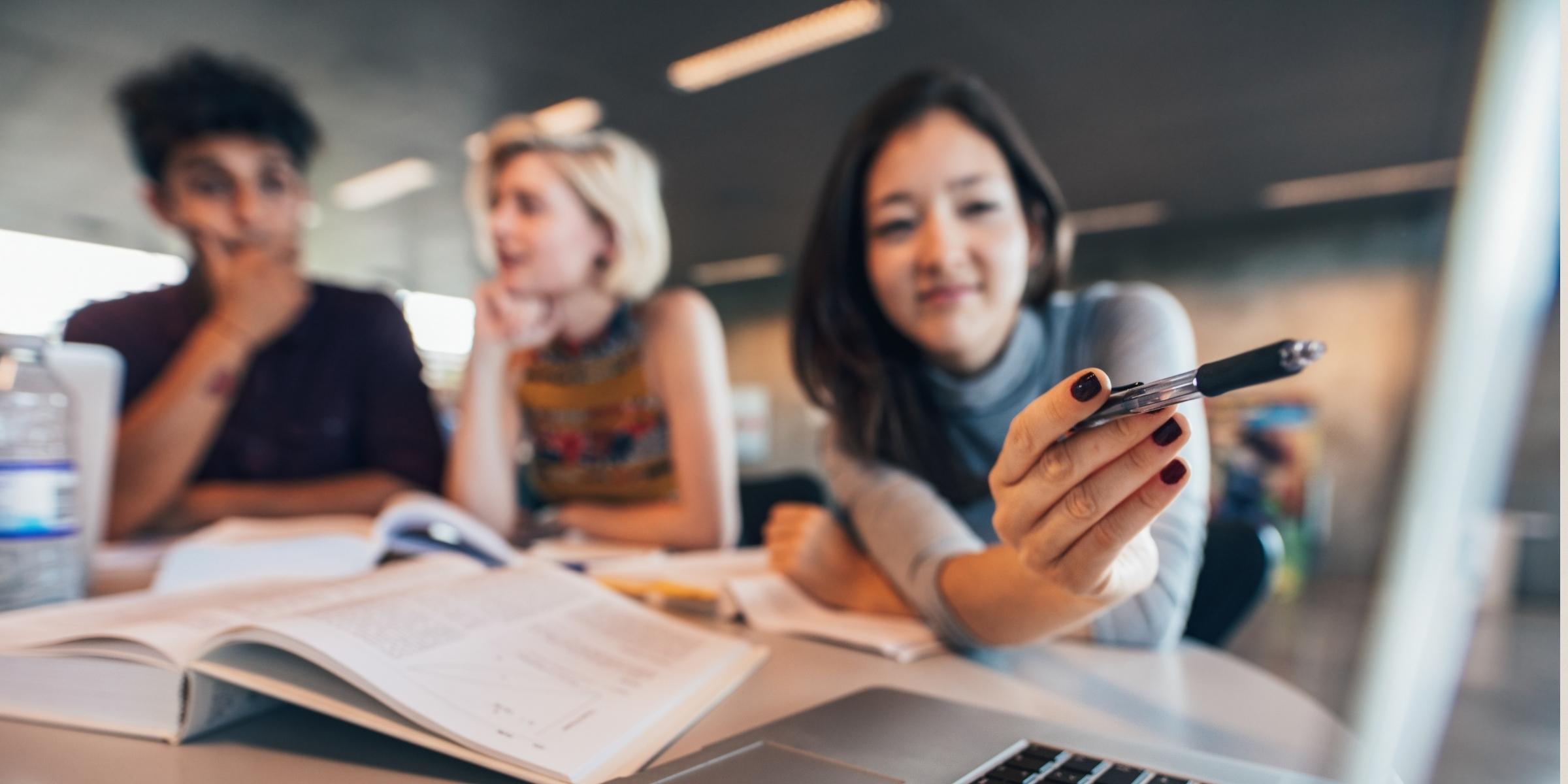 three people focusing on a computer screen