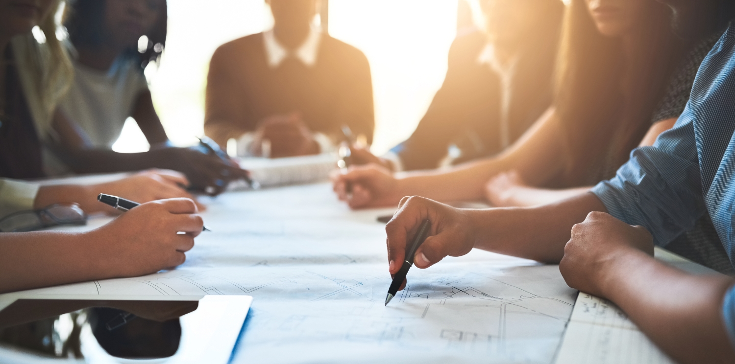 group of people working around a conference room table