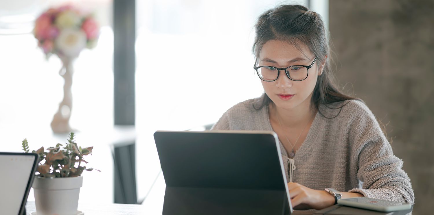 a student looking at a laptop