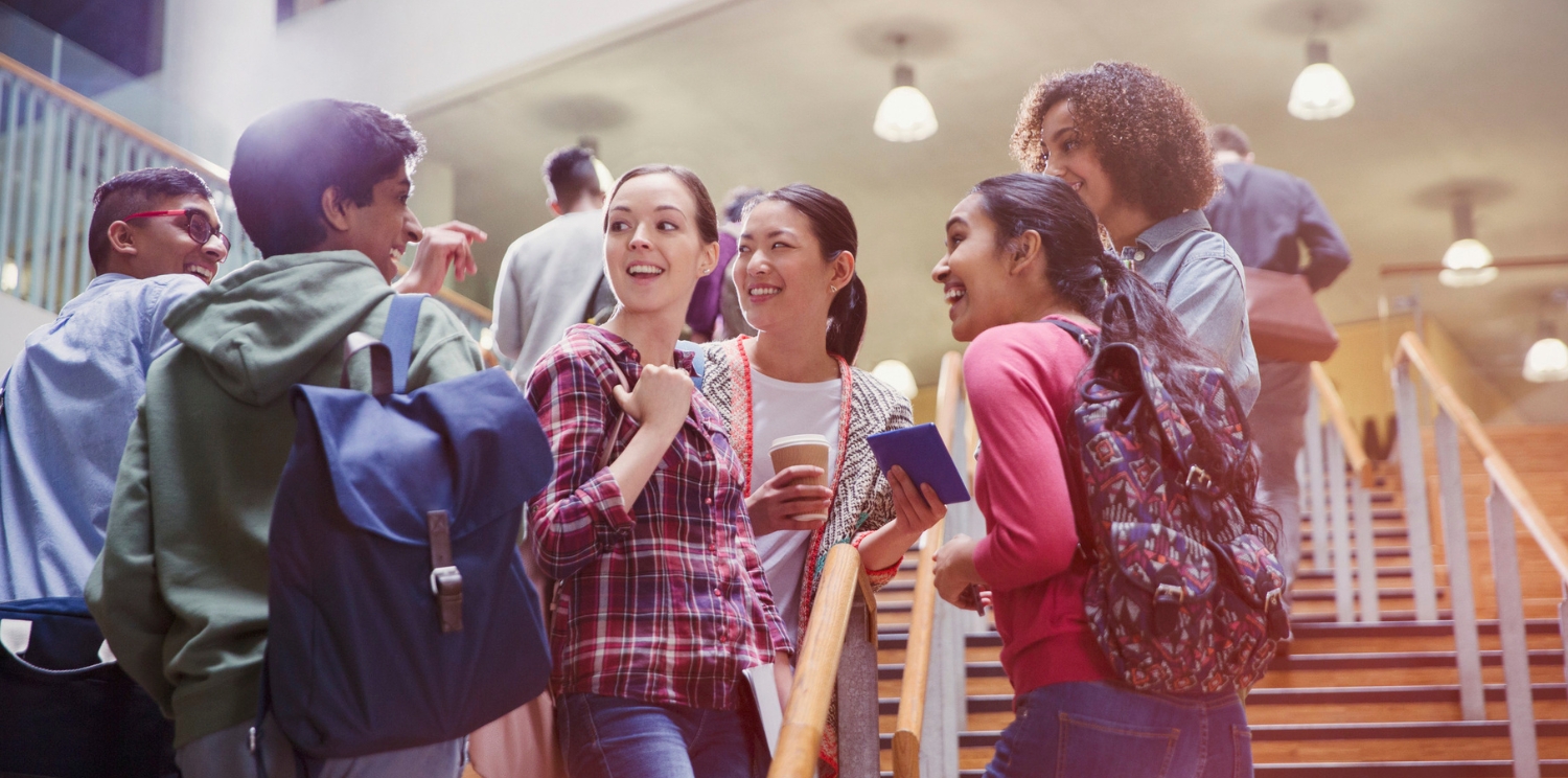 a group of students chatting on a stairway