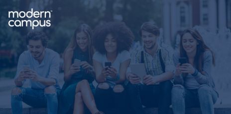 a group of students sitting next to each while smiling at their cell phones